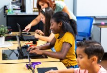Middle school students working on laptops