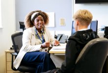 Adult mentor talking to student