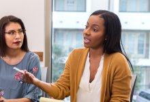 A photo of a school administrator leading a meeting with other leaders.