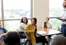 A photo of a high school classroom having an engaging discussion.