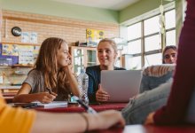 A photo of a small group of students working collaboratively in the classroom.
