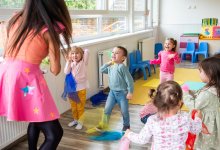A photo of a teacher engaging her students through a dance and movement session.