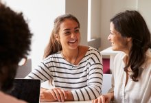 A photo of a conference between a student, a teacher, and the student's parent.