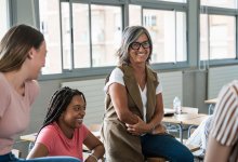 A photo of a teacher in an engaging, casual discussion.