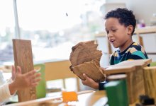 Preschool students playing with pieces of wood