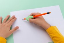 Student using a claw pencil grip for writing