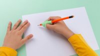 Student using a claw pencil grip for writing