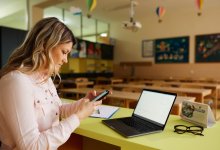 A photo of a teacher contacting parents through a mobile app.