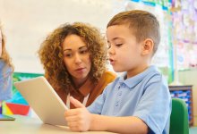 Student reading out loud from a tablet