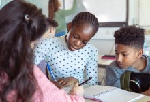 A photo of a small group of middle school students collaborating during math class.