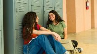 Two students talking in a school hallway
