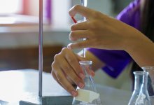 A photo of a high school student performing a titration.