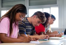 A photo of high school students working on a writing assignment in class.