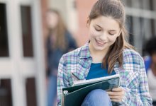 Student writing in a notebook
