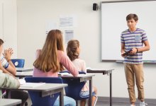 A photo of a high school student presenting a short speech in front of his classmates
