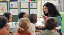 Teacher reading picture book to students