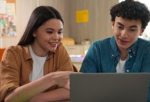 Two student making a reaction video on a laptop