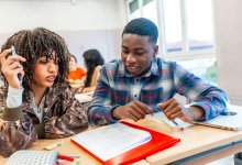 A photo of two students reviewing class material.