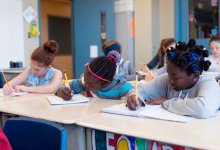 A photo of elementary students engaged in a writing assignment.