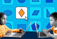 Two elementary students are playing a math-based game together using their laptops