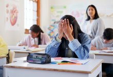photo of a student who appears stressed out in a classroom