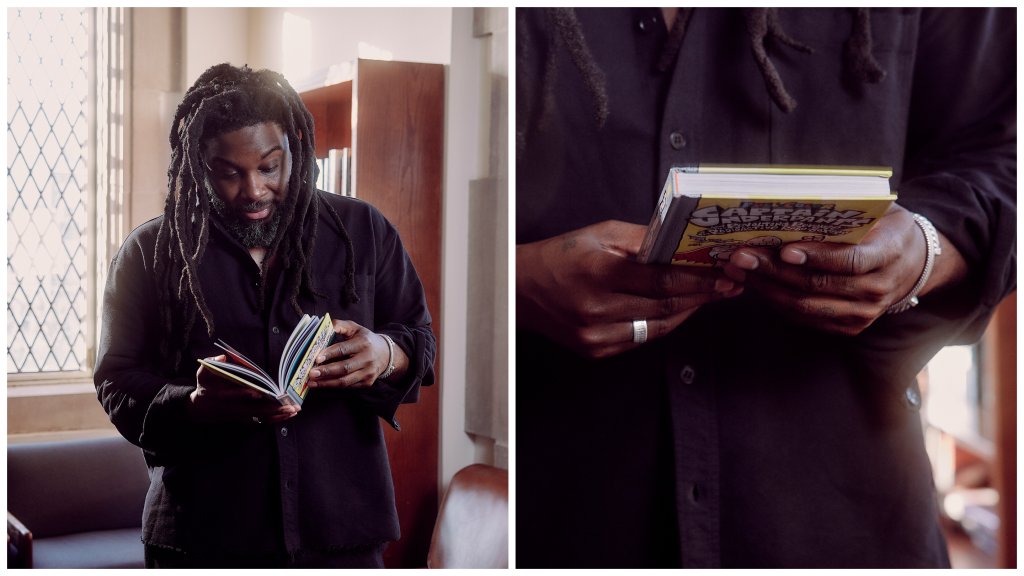 Jason Reynolds reads a copy of Captain Underpants