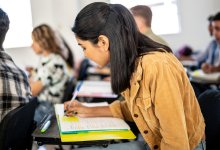 High school student taking notes on a sticky note