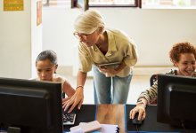 Computer science teacher helping students