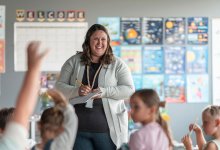 Teacher taking notes in front of the class