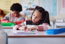 Elementary student taking notes