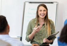 A photo of a teacher presenting to other staff