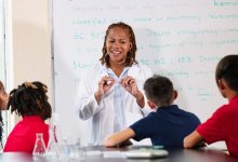 Science teacher instructing students