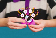 Math symbols and a task card flying out of a plastic egg an elementary student is opening