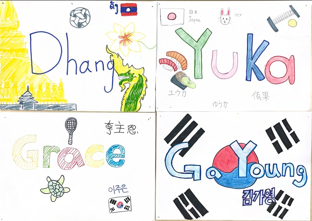 A photo of four student name tags decorated with elements of their respective cultures