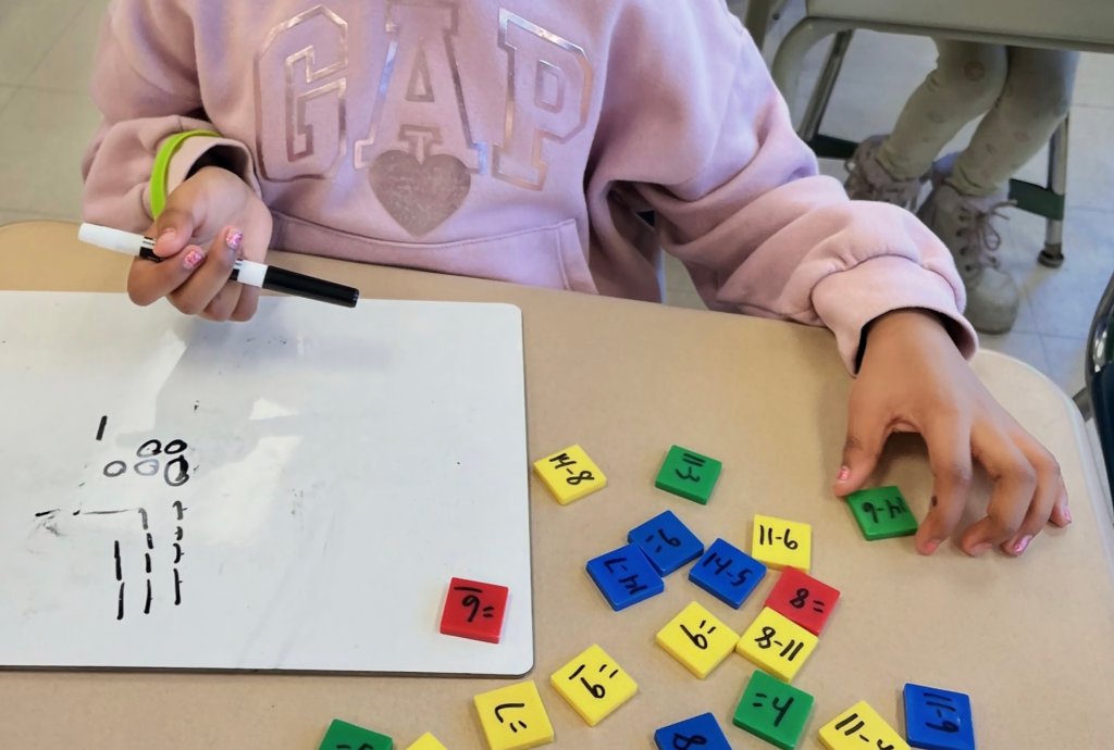 Elementary student completing math fluency block activity