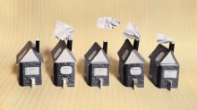 photo of a row of houses made from composition notebooks