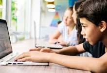 A photo of students working on a writing assignment using their laptops
