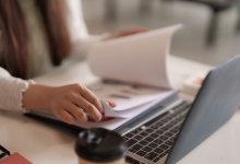 Woman looking through pages of data