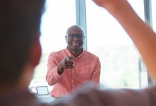 A photo of a teacher calling on an engaged student