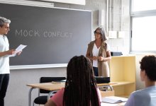 A photo of a student and teacher engaging in a mock scenario
