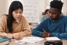 Two high school students working together