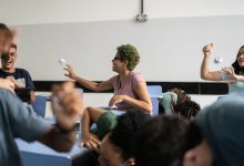High school class throwing paper balls at each other during test prep game