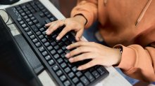 Teenager typing on a keyboard