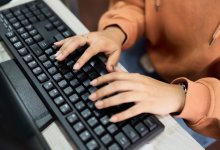 Teenager typing on a keyboard