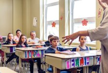 A photo of elementary students attentively listening to their teacher