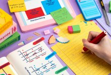 image of someone taking notes on a desk with all objects made from paper.
