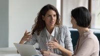 A school administration speaking to a teacher with compassion