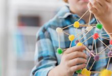 Student creating science project with gumdrops and toothpicks