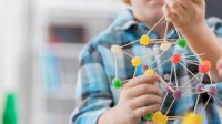Student creating science project with gumdrops and toothpicks