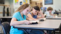 Elementary students reading books in class